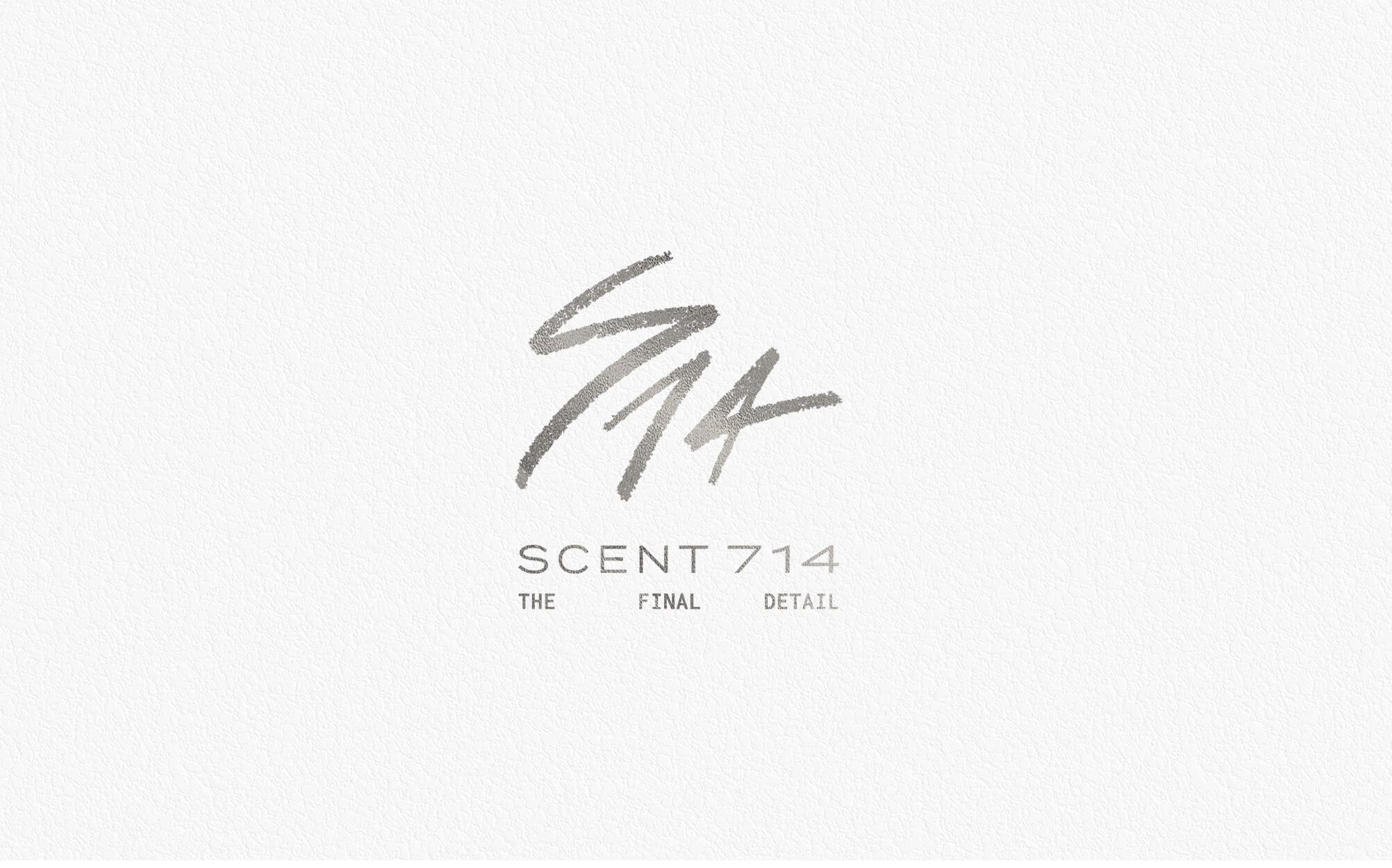 Jacober Creative Brand Identity for Scent 714 Custom Fragrances. Photo of logo in silver foil on a textured background.
